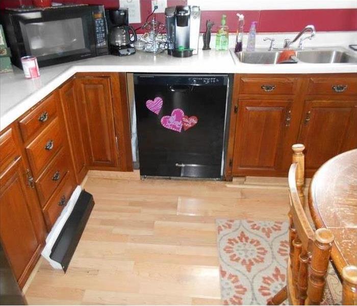 A picture of a kitchen with water damage due to a dish washer.