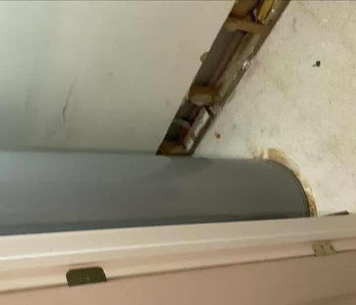 A picture of fixing the water damage in the wall due to a hot water tank.