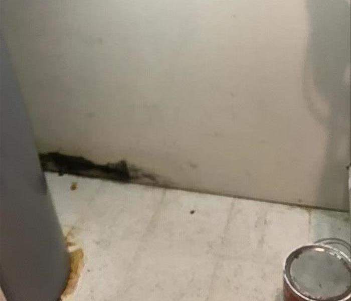 A picture of water damage due to a hot water tank.