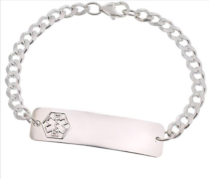 A picture of a silver medical bracelet.