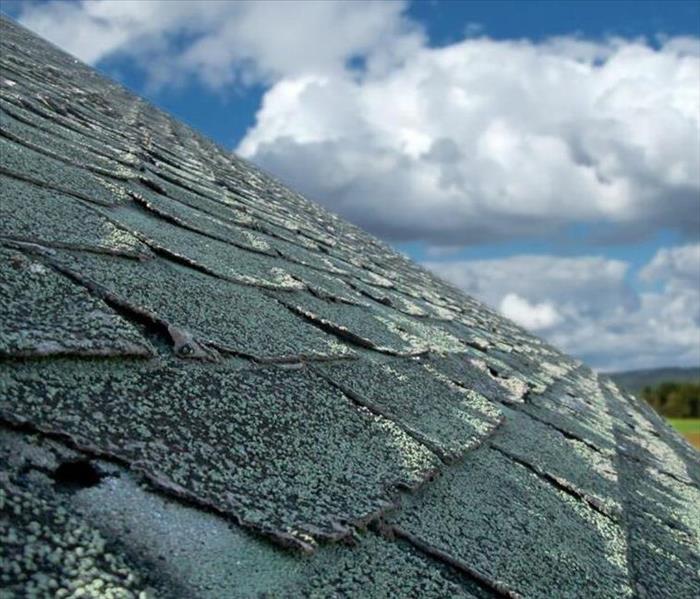 A picture of a roof that has hail damage to the shingles.